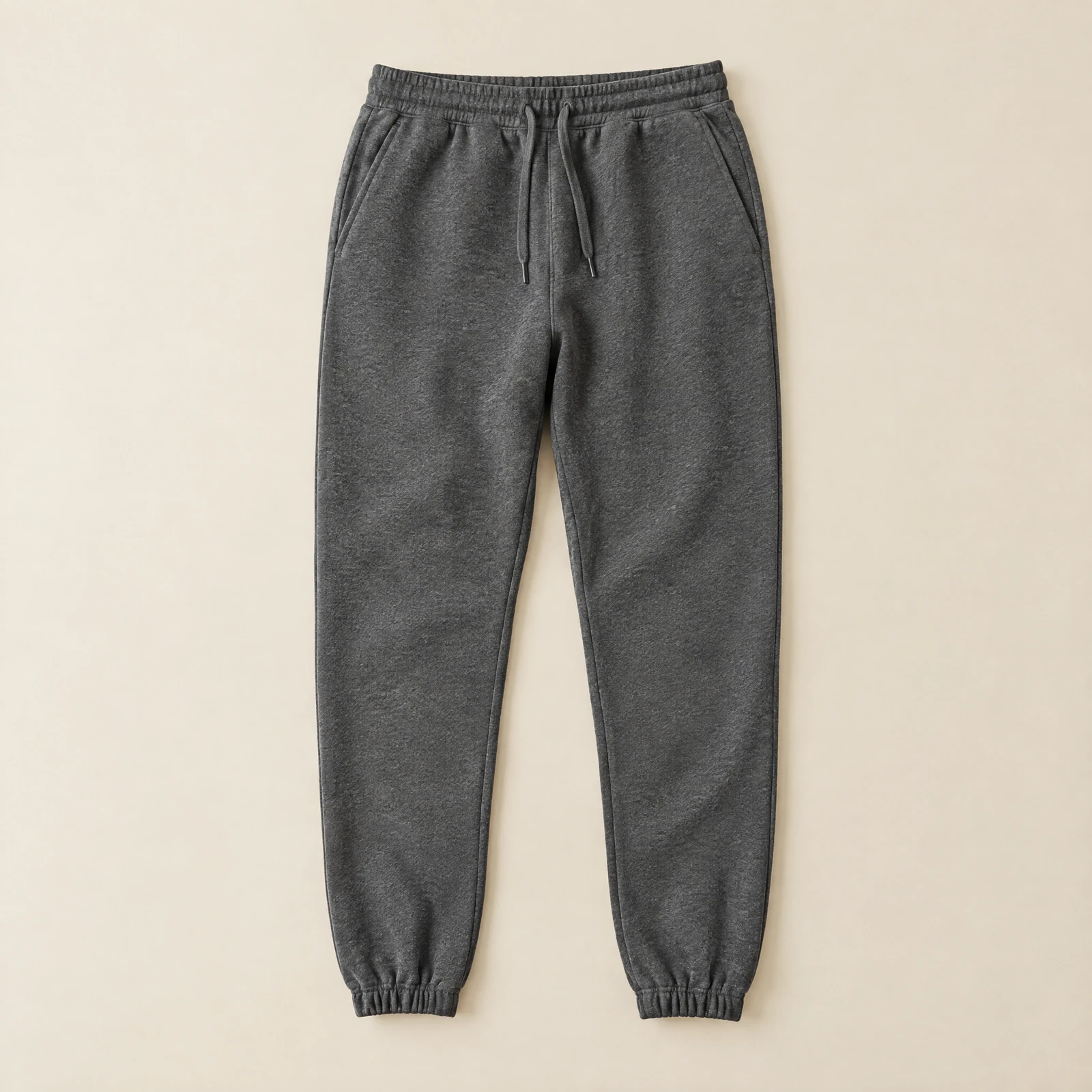 Dark heather grey men's jogger sweatpants with drawstring laid flat